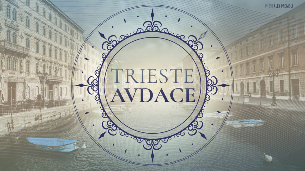 Scritta "TRIESTE AVDACE" in decorazione blu su foto della città. Copertina dell'open call fotografica dedicata a Trieste